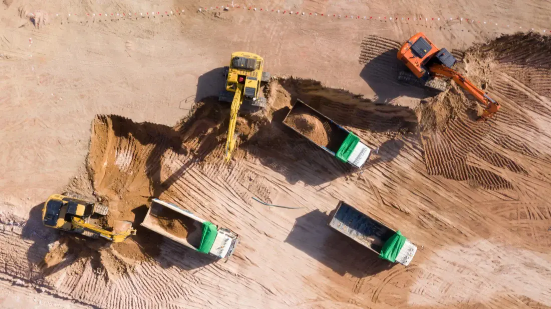 Escavators-putting-soil-on-trucks