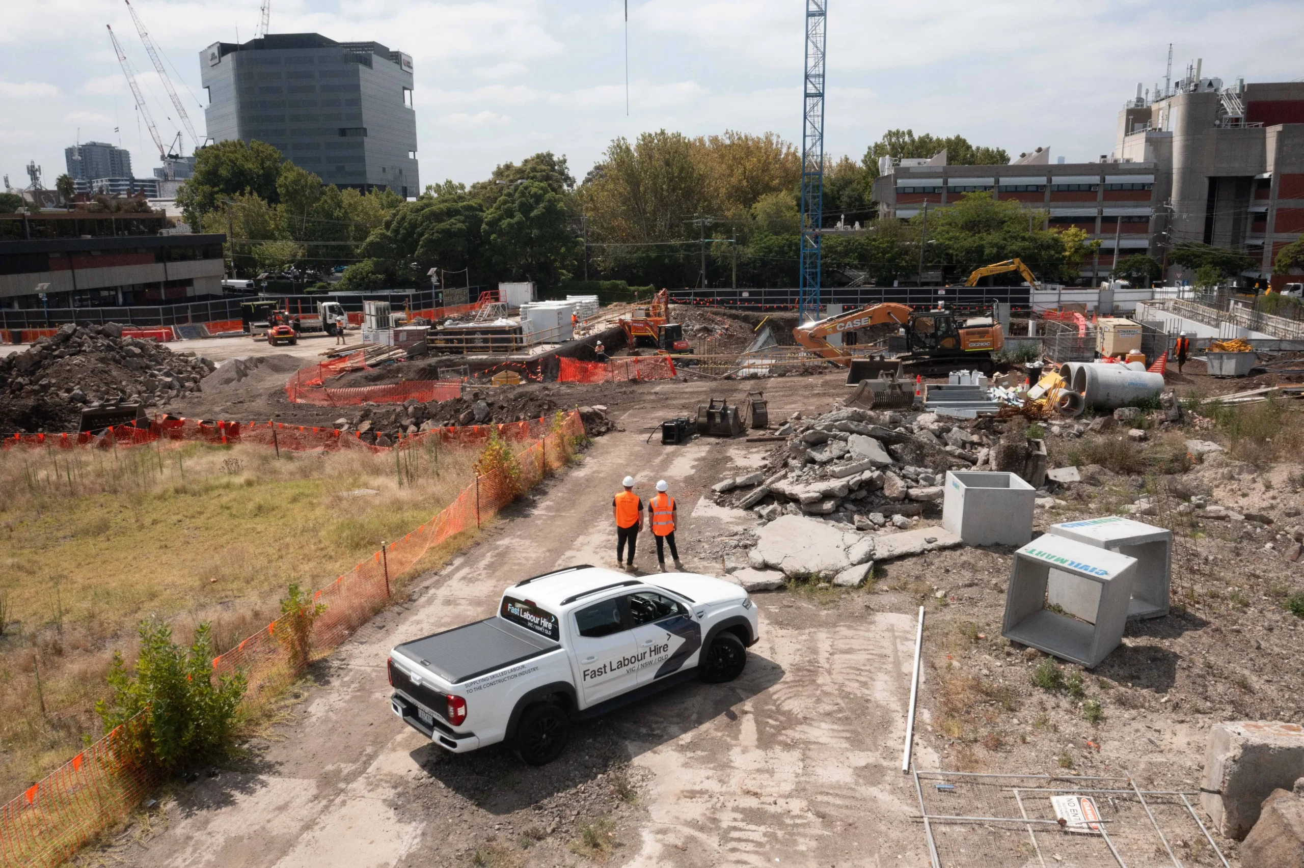 Fast Labour Hire workers beside a company vehicle at an active infrastructure site.