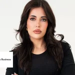 founder-friday-maria-kathopoulis | Fast Labour Hire Professional woman with long dark hair wearing a black top, looking at the camera against a light background.